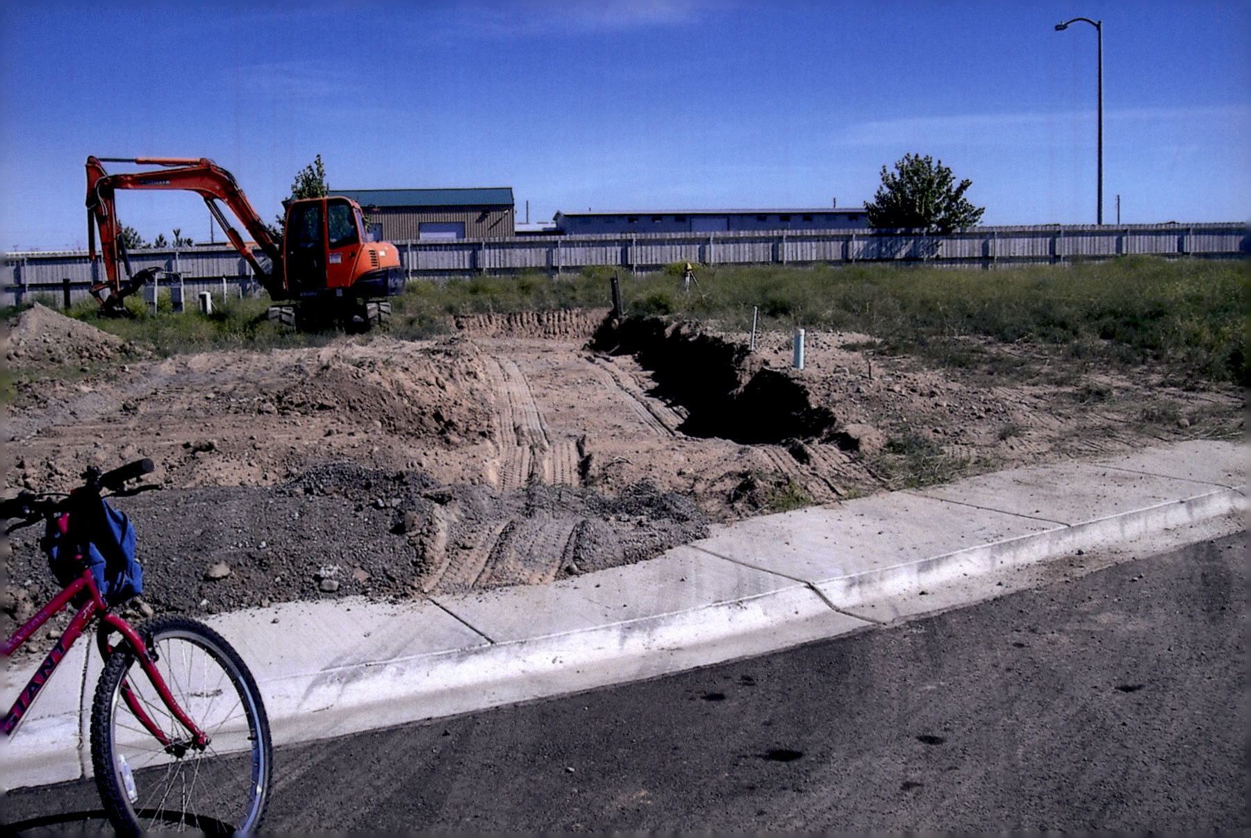 "Cutting the hole" — creating a level surface for the concrete runners used to support the blocks for jacking the home.
