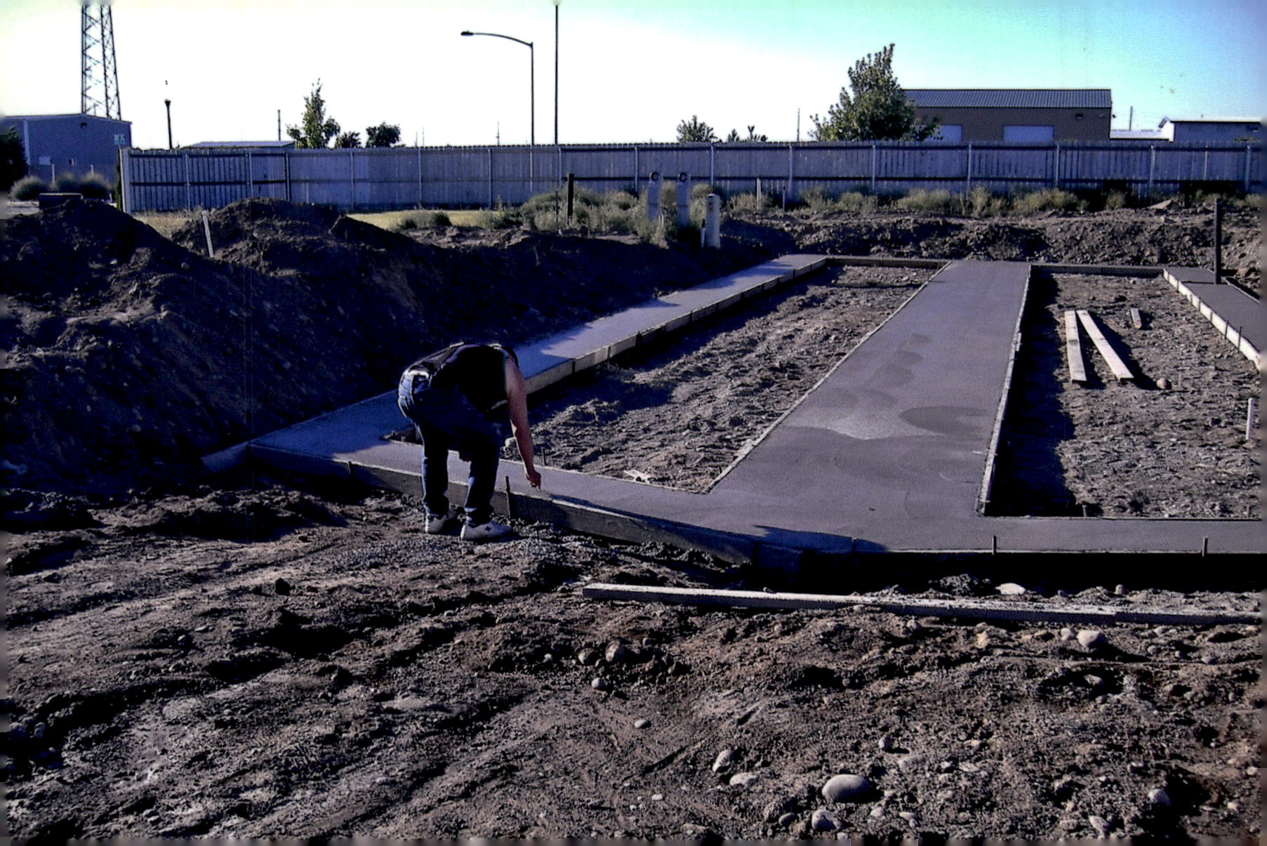 Concrete runners are poured. Using concrete under just the blocking points saves time compared to pouring a full slab.